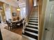 Elegant dining area adjacent to staircase featuring wood floors and a large window at 10532 Cory Lake Dr, Tampa, FL 33647