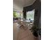Bright dining area features a modern table set, with views of the pool area, creating a perfect indoor/outdoor flow at 10532 Cory Lake Dr, Tampa, FL 33647