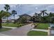 Beautiful home with a paver driveway, mature landscaping, and well-manicured lawn at 10532 Cory Lake Dr, Tampa, FL 33647