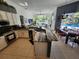 Modern kitchen featuring stainless steel appliances, granite countertops, and an open view to the pool area at 10532 Cory Lake Dr, Tampa, FL 33647