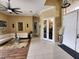Open concept living room with tile flooring and a fur rug at 10532 Cory Lake Dr, Tampa, FL 33647