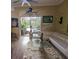 Living room featuring comfortable seating, a glass coffee table, and views of the outdoor pool area at 10532 Cory Lake Dr, Tampa, FL 33647