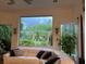 Cozy living room with comfortable seating, large windows with tropical views, and neutral decor at 10532 Cory Lake Dr, Tampa, FL 33647