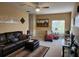 Spacious living room with ample seating, a ceiling fan, and plenty of natural light at 10532 Cory Lake Dr, Tampa, FL 33647