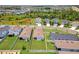 Wide aerial view of homes with well-kept lawns in a Gathering-friendly neighborhood with mature landscaping at 10945 High Noon Trl, Parrish, FL 34219