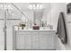 Modern bathroom with a double sink vanity, ample counter space, and a glass-enclosed shower for a luxurious feel at 10945 High Noon Trl, Parrish, FL 34219