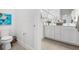 Bright bathroom with dual vanity, modern fixtures, and glass-enclosed shower at 10945 High Noon Trl, Parrish, FL 34219
