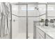 Stylish bathroom featuring a glass-enclosed shower, white tiling, and modern fixtures for a clean, spa-like experience at 10945 High Noon Trl, Parrish, FL 34219