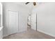 Bedroom featuring neutral carpet, ceiling fan, window and closet storage at 10945 High Noon Trl, Parrish, FL 34219