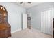 Bedroom with built in cabinet, neutral carpet, ceiling fan, window and closet storage at 10945 High Noon Trl, Parrish, FL 34219