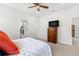 Serene bedroom with soft carpet, a dresser, and a doorway to an adjoining bathroom for added convenience at 10945 High Noon Trl, Parrish, FL 34219