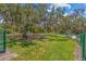 Well-maintained dog park with green grass and mature trees offering ample shade at 10945 High Noon Trl, Parrish, FL 34219