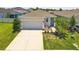 Charming single-story home featuring a manicured lawn, a two-car garage and a lovely, covered front entryway at 10945 High Noon Trl, Parrish, FL 34219