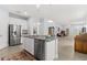 Open concept kitchen with stainless steel appliances, granite countertops, and an island featuring a sink at 10945 High Noon Trl, Parrish, FL 34219