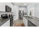 Modern kitchen showcasing stainless steel appliances, granite countertops, and white cabinets, offering style and functionality at 10945 High Noon Trl, Parrish, FL 34219