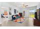 Cozy living room with comfortable blue sofa, decorative rug, and sliding glass doors leading to the outside at 10945 High Noon Trl, Parrish, FL 34219