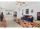 Open-concept living space with tile flooring, a comfortable sofa, and a view of the modern kitchen at 10945 High Noon Trl, Parrish, FL 34219