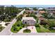 Beautiful aerial view of a coastal home with a circular driveway and lush landscaping at 1156 2Nd S Ave, Tierra Verde, FL 33715