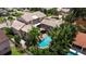 Aerial view of a luxurious home with a private pool and spa surrounded by tropical foliage at 1156 2Nd S Ave, Tierra Verde, FL 33715