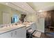 Contemporary bathroom with double sinks, a walk-in shower, and sleek white cabinets at 1156 2Nd S Ave, Tierra Verde, FL 33715