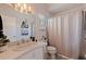 Bathroom featuring a sink, toilet, shower with curtain, mirror and decor at 1156 2Nd S Ave, Tierra Verde, FL 33715