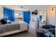 Stylish bedroom with royal blue curtains, a ceiling fan, and decorative mirror at 1156 2Nd S Ave, Tierra Verde, FL 33715