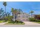 Beautiful, two-story home with lush tropical landscaping, a brick driveway and an attached three-car garage at 1156 2Nd S Ave, Tierra Verde, FL 33715