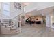 Elegant foyer with a curved staircase, piano, and expansive open floor plan leading to the living areas at 1156 2Nd S Ave, Tierra Verde, FL 33715
