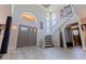 Grand entryway with soaring ceilings, unique light fixtures, elegant staircase, and stylish gray-toned floors at 1156 2Nd S Ave, Tierra Verde, FL 33715
