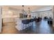 Bright open-concept kitchen featuring a center island, stainless appliances, and seamless flow to the living area at 1156 2Nd S Ave, Tierra Verde, FL 33715