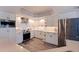 Modern kitchen with white cabinetry, stainless steel appliances, and contemporary finishes at 1156 2Nd S Ave, Tierra Verde, FL 33715