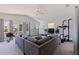 Spacious room with modern exercise equipment, a TV and comfortable sectional sofa at 1156 2Nd S Ave, Tierra Verde, FL 33715