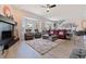 Open concept living room with a fireplace, recliner seating, and views from the bay window at 1156 2Nd S Ave, Tierra Verde, FL 33715