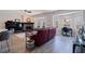 Bright living room featuring a modern fireplace, large windows, and hardwood floors leading to an office space at 1156 2Nd S Ave, Tierra Verde, FL 33715