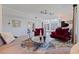 Bright living room with red couches, gray sectional, and a grand piano near the front entry at 1156 2Nd S Ave, Tierra Verde, FL 33715