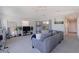 Cozy living room with a gray sofa, television, plants, mirror, and a ceiling fan at 1156 2Nd S Ave, Tierra Verde, FL 33715