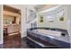 Luxurious bathroom featuring a modern bathtub, dual windows, and an entrance to the main bedroom at 1156 2Nd S Ave, Tierra Verde, FL 33715