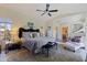 Spacious main bedroom with a large bed, a ceiling fan, and a walk-in closet leading to the main bathroom at 1156 2Nd S Ave, Tierra Verde, FL 33715