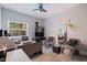 Bright home office with a desk, two chairs, a large window, and a ceiling fan for added comfort at 1156 2Nd S Ave, Tierra Verde, FL 33715