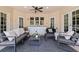 Covered patio with stylish outdoor seating, a ceiling fan, and convenient counter space with built-in cabinets at 1156 2Nd S Ave, Tierra Verde, FL 33715