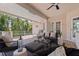 A covered outdoor patio featuring stylish seating and a ceiling fan for comfortable relaxation at 1156 2Nd S Ave, Tierra Verde, FL 33715
