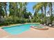 Beautiful pool and spa surrounded by lush landscaping and lounge chairs at 1156 2Nd S Ave, Tierra Verde, FL 33715