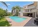 Backyard pool and spa with a spacious patio, set against the home's exterior at 1156 2Nd S Ave, Tierra Verde, FL 33715