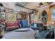 Unique rec room with surfboards, skateboards, comfortable seating, and a vibrant, fun atmosphere at 1156 2Nd S Ave, Tierra Verde, FL 33715