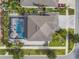 Aerial view showcasing the home with a screened-in pool, patio, and well-manicured landscaping at 11602 Sunburst Marble Rd, Riverview, FL 33579