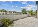Long view of the backyard featuring gray brick paving and a white vinyl fence at 11602 Sunburst Marble Rd, Riverview, FL 33579