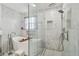 Luxurious bathroom with marble walls, soaking tub and a glass-enclosed shower at 11602 Sunburst Marble Rd, Riverview, FL 33579