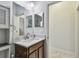Bathroom with modern sink, vanity, and a glimpse of the tiled shower through the mirror at 11602 Sunburst Marble Rd, Riverview, FL 33579