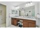 Luxurious bathroom features double vanity with ample counter space and modern fixtures at 11602 Sunburst Marble Rd, Riverview, FL 33579