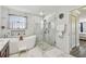 A luxurious bathroom featuring a soaking tub and a glass-enclosed shower at 11602 Sunburst Marble Rd, Riverview, FL 33579